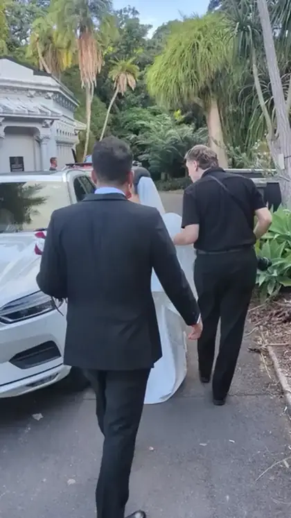 Following the couple out to the car